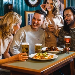 Friends sharing food and drinks in the pub