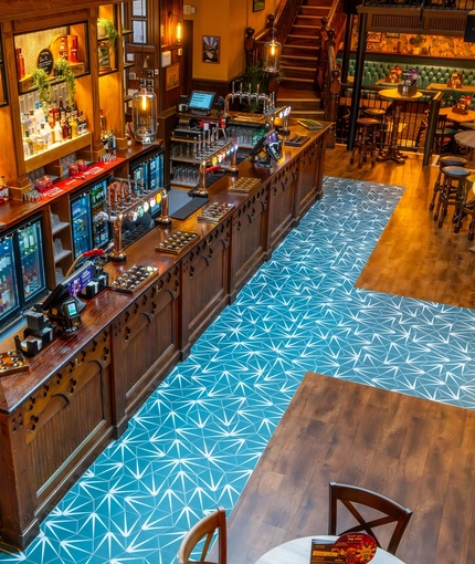 A view from the upper floor balcony of the wood panelled bar inside the Old School House, and some of the ground floor restaurant seating areas.