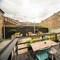 The exterior beer garden and seating area with benches and tables and chairs at the Armstrongs.