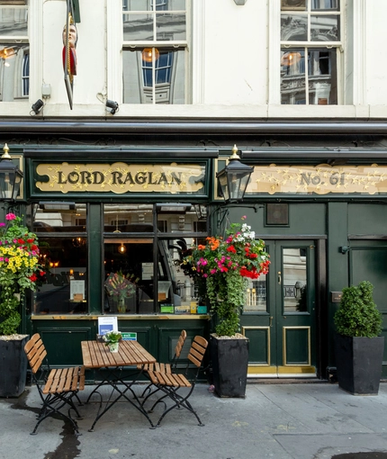 External view of a pub entrance and outdoor seating area