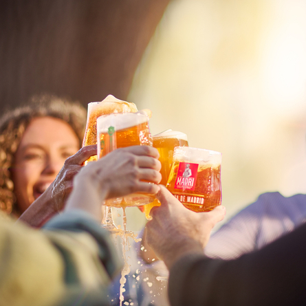 An image of 4 friends enjoying drinks within the exterior beer garden area and celebrating with a cheers at a Chef & Brewer venue.