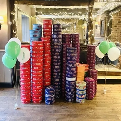 Stacks of Christmas sweet tubs in a pub.