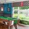 Interior area of a pub with a pool table.