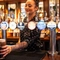 An image of a member of staff placing a pint of Guinness on the interior bar at The Crabtree.