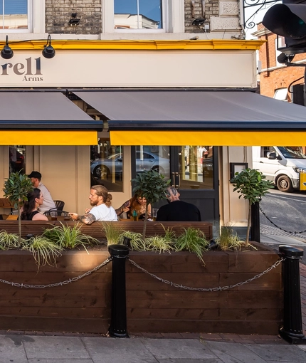 The exterior beer garden seating area being enjoyed during the launch party at The Durell Arms.
