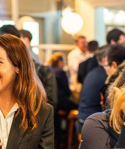 An image of a group of friends sat within the interior seating area enjoying various drinks at The Kings Stores.