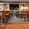 The interior restaurant seating area with TV and electronic pub game at The Greengage.