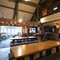 Interior dining area of a pub with a gambling machine.