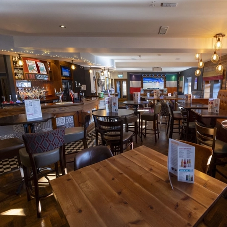 The interior bar and restaurant seating area with TV at The Capelrig.