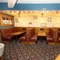 Interior dining area of a pub with TV screens.