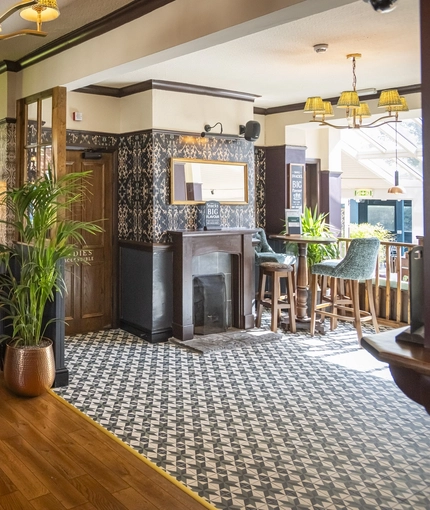 The interior restaurant seating area with feature fireplace at The Crown & Horseshoes.