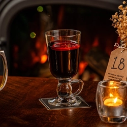 A glass of mulled wine served by the fire at The Three tuns.