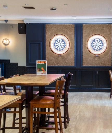 The interior restaurant, seating and games area with dart boards area at the Poachers.