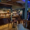 An image of the interior bar and restaurant seating area with TV and electronic pub games at The Guild.