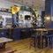 Interior dining area of a pub with TVs and a bar.