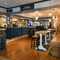 Interior dining area of a pub with a bar and a TV.