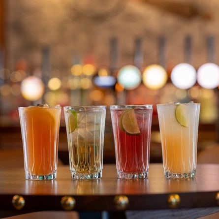 A selection of mocktails on a wooden table of a pub