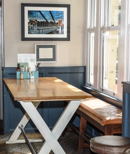 Interior dining area of a pub with a TV.