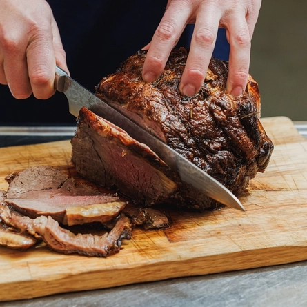 A Chef carving a joint of beef at the carvery deck at Crafted Venues.