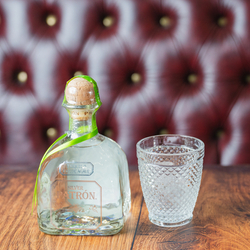 An advertising image of a bottle and glass of Patron Silver Tequila.