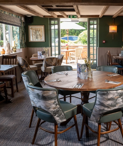 Some tables in the restaurant of the Three Horse Shoes.