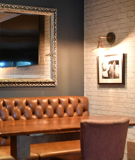 interior dining area of a pub with a TV