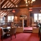 Interior dining area of a pub with a fireplace.