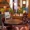 The interior restaurant seating area at The Fox in Bury St Edmunds, with a wood panelled column, and upholstered chairs.