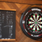 A dartboard and scoreboard on the wall inside Coopers in Glasgow.