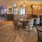 Interior dining area of a pub with a bar and a gambling machine.