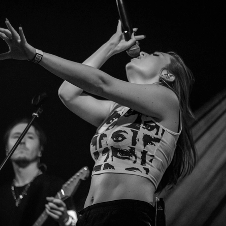 A woman singing on a stage