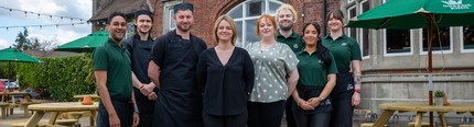 Members of staff of the Golden Hind in Cambridge, standing outside in front of the pub.