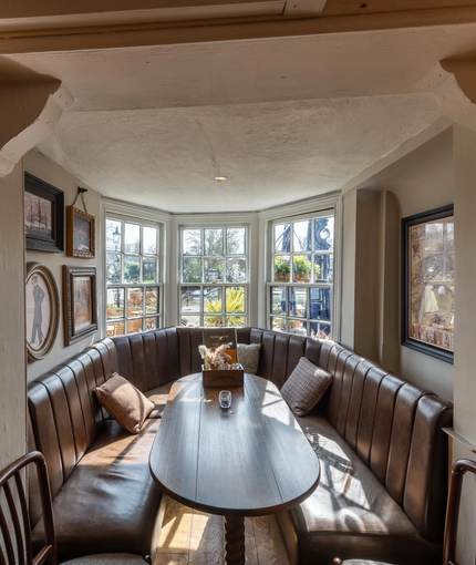 Interior seating area with one large table in a window