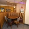 Interior dining area of a pub with a gambling machine.