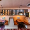 Interior dining area of a pub with a few TVs.