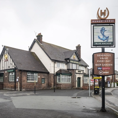 Exterior facade of a pub with a signage.