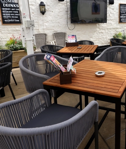 An exterior shot of the beer garden, seating area & decor at The Palmeira in Hove.