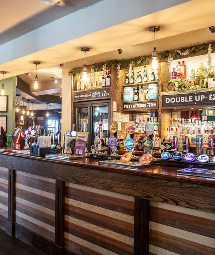 Interior bar area of a pub with a few gambling machines.