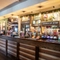 Interior bar area of a pub with a few gambling machines.