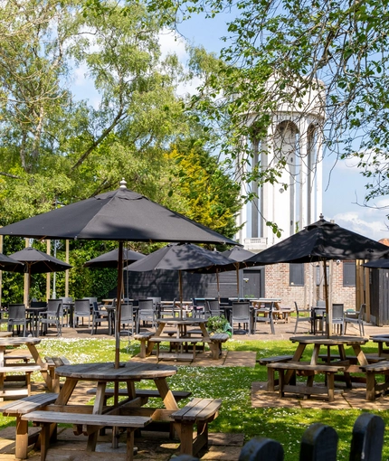 Exterior beer garden of a pub with a seating area.