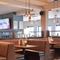 The interior restaurant seating area with seating booths and TV at The Quays.