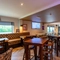 Interior dining area of a pub with a few TVs.