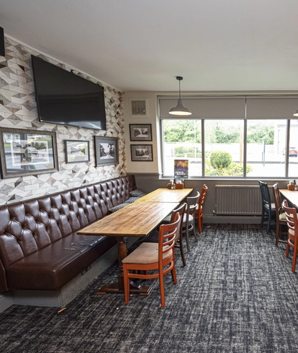 Interior dining area of a pub with a TV.