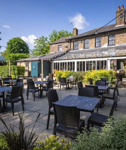 The exterior beer garden seating area with the venue in the background at The Crown & Horseshoes.