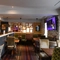 Interior dining area of a pub with a TV.