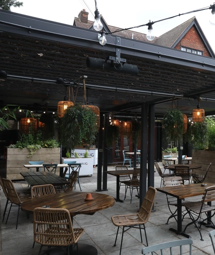 Undercover Exterior  Beer Garden seating area with wicker chairs and lots of plants