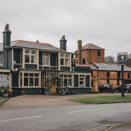 The exterior and part of the car park of The Prince Of Wales.