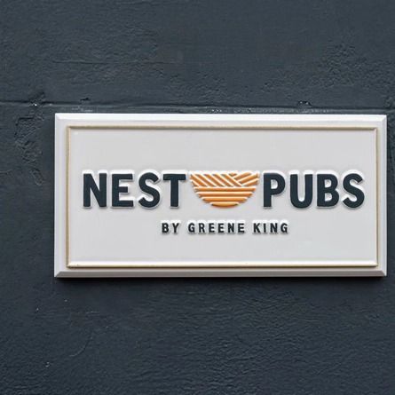 A exterior sign for 'Nest Pubs.'