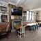 Interior dining area of a pub with a TV and a fireplace.