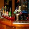 A close up view of the beer taps and golden drinks trays on the bar inside The Windmill Inn.